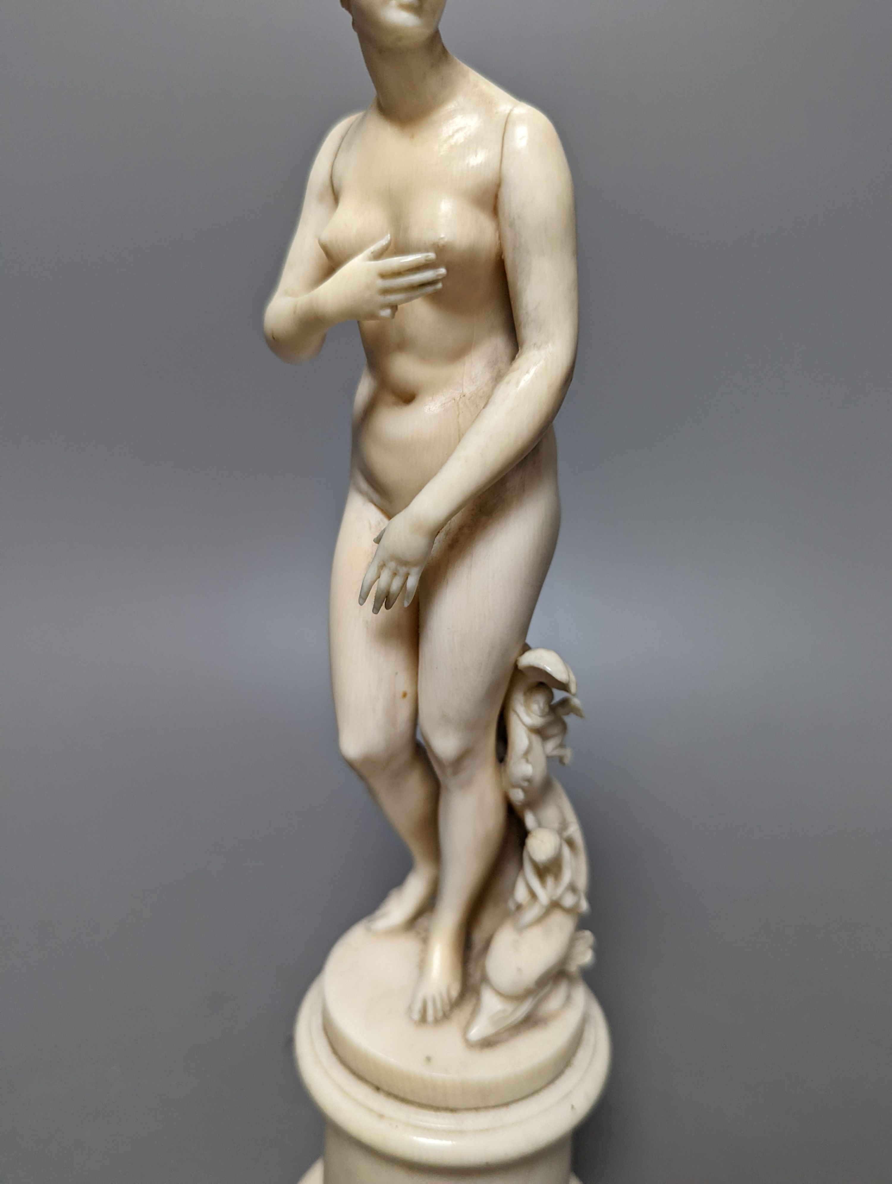 A 19th century Dieppe ivory figure after the antique ‘Venus with dolphin’ 25cm